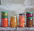 Variety of preserved food in glass jars - pickles, jam, marmalade, sauces, ketchup. Preserving vegetables and fruits. Fermented fo Royalty Free Stock Photo