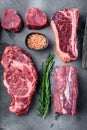 Variety of Raw Black Angus Prime meat steaks, tomahawk, t bone, club steak, rib eye and tenderloin cuts, on gray stone background Royalty Free Stock Photo