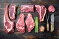 Variety of Raw Black Angus Prime meat steaks, tomahawk, t bone, club steak, rib eye and tenderloin cuts, on old dark  wooden table Royalty Free Stock Photo