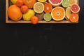 Variety of ripe citruses on black background Royalty Free Stock Photo