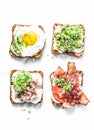 Variety of sandwiches for breakfast, snack, appetizers - avocado puree, fried egg, tomatoes, bacon, cream cheese, smoked mackerel Royalty Free Stock Photo