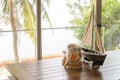 Variety of sea shells in glass jar on wooden table with copy space in living room. holiday concept Royalty Free Stock Photo