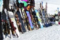 Variety of skies and snowboards standing outside a mountain bar