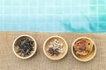 Variety of spice and herbs in wooden bowl with space on blue water background