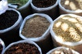 Variety of spices in the Asian market. Grains of different spices in large bags close-up. Zira, coriander, cloves, star anise,