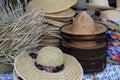Variety of straw hats on table at outdoor island market