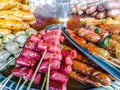 Variety of streamed sausages and meatballs dipped in hot and spicy chilli sauce