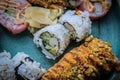 A variety of supermarket sushi on a rustric platter - close-up Royalty Free Stock Photo