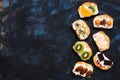 A variety of sweet sandwiches with fruit on a blue rustic background. Top view, copy space. Royalty Free Stock Photo