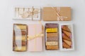 Variety of sweets in windowed and sealed boxes. Top view. On white surface