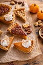 Variety of Thanksgiving pie slices on parchment paper