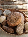 Variety of traditional breads and buns in basket at bakery