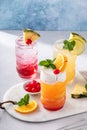Variety of tropical tiki cocktails in fun tiki glasses garnished with slices of fruit and mint Royalty Free Stock Photo