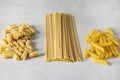 Variety of Types and Shapes of Dry Italian Pasta Italian Macaroni Raw Food Background or Texture Spaghetti Penne Fusuli Horizontal Royalty Free Stock Photo