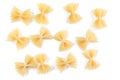 Variety of types and shapes of Italian pasta. Dry pasta background. A portion of Farfalle bows pasta isolated on white . Heap of Royalty Free Stock Photo