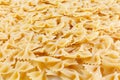 Variety of types and shapes of Italian pasta. Dry pasta background. A portion of Farfalle bows pasta isolated on white . Heap of Royalty Free Stock Photo