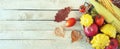 Variety of vegetables and fruits in a wicker basket on a wooden background Royalty Free Stock Photo