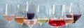 Variety of wine colors panorama. Red, rose, and white wine in elegant glasses Royalty Free Stock Photo