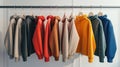 a variety of youth cashmere sweaters, hoodies, and sweatshirts arranged neatly on a clothes rack, suitable for mock-up