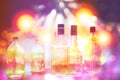 Various alcohol bottles in party with colourful light Royalty Free Stock Photo