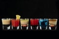 Mix alcoholic cocktail shots together with isolated black background Royalty Free Stock Photo