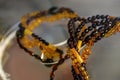 Various amber beads on a glass shelf