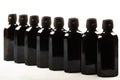 Various amber glass bottles for cosmetics, natural medicine , essential oils or other liquids isolated on a white background, top