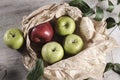 Various apples on a wooden tabletop Royalty Free Stock Photo