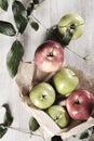 Various apples on a wooden tabletop Royalty Free Stock Photo