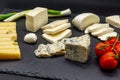 Various assorted cheese on black slate