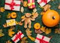 Various autumn leaves and orange pumpkins near teddy bear toy