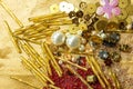 Various beads and sequins on yellow shiny fabric