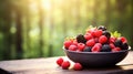 Various berries in a bowl against the backdrop of the garden. Selective focus. Royalty Free Stock Photo