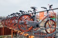 Various bicycles on a rack, available for rent