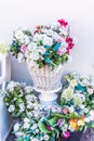 Various blooming arrangements in pots and vases as a decoration in front of a house.