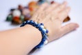 Various blue mineral bracelets on a young womans wrist Royalty Free Stock Photo