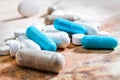 Blue and white tablets on wooden table Royalty Free Stock Photo