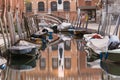 Boats docked on a canal in Venice, Italy and sunset light Royalty Free Stock Photo