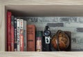 Various books, Movie camera 8mm, Replica globe and Pencils on wooden shelf