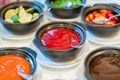 Various bowls of assorted sauces, dips on a asian cuisine buffet Royalty Free Stock Photo