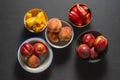 Various bowls of nectarines, peaches and yellow and other red peppers Royalty Free Stock Photo
