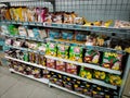 various brands of chips and potato chips in Indonesia are displayed on supermarket shelves.
