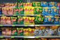 Various brands of potato chips Lay`s, Estrella, and Cheetos on shelf in a grocery store. Minsk, Belarus, 2022