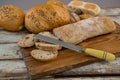 Various bread loaves with knife Royalty Free Stock Photo