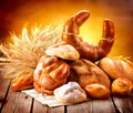 Various bread and sheaf of wheat ears Royalty Free Stock Photo