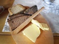 Various of bread, whole grain with butter and wooden knife on wooden board on the table Royalty Free Stock Photo