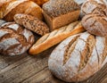Various breads, displayed on a rustic wooden table, AI Royalty Free Stock Photo
