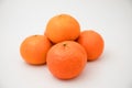 Various orange citrus fruit laying stack against white background