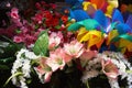 Various brightly colored artificial flowers for sale