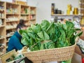 Various bunches of fresh spinach in a wicker basket